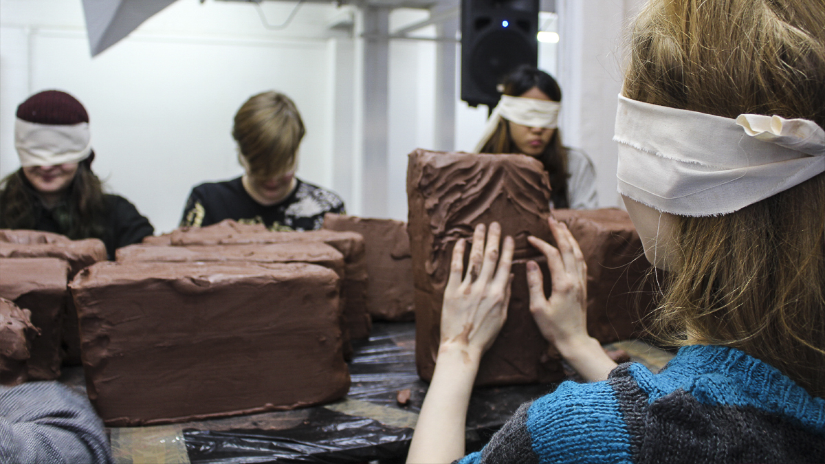Students attending a blindfolded clay workshop