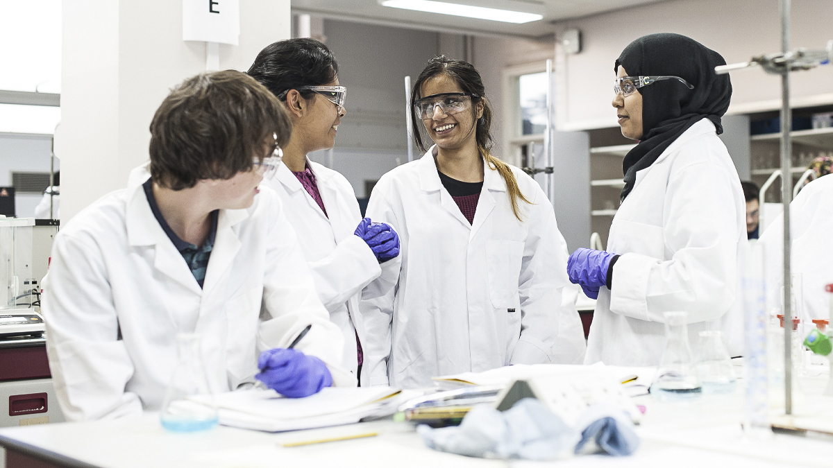 Group of students chatting in a science lab