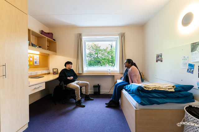 Students sat talking in bedroom