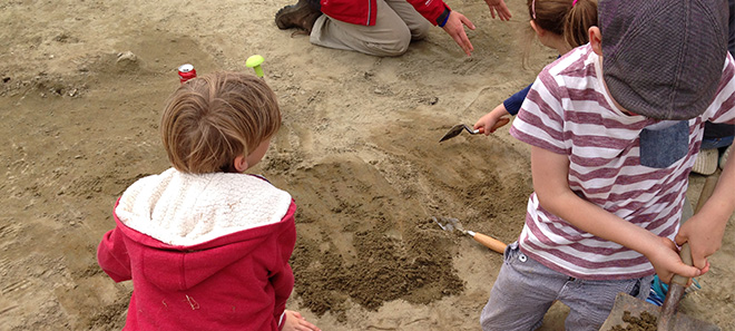 Children on archaeological dig image