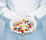 person holding various pills