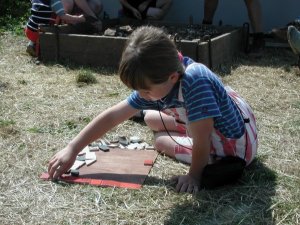 Visitor Anna making a mosaic