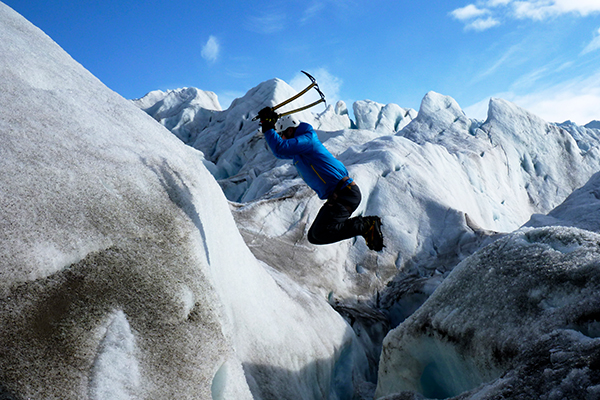 Student skiing in snowy mountains