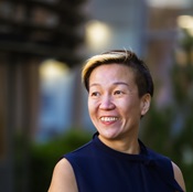 Head shot of woman with short dark brown hair smiling at camera