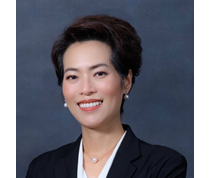 Female with black hair in an updo smiling at camera