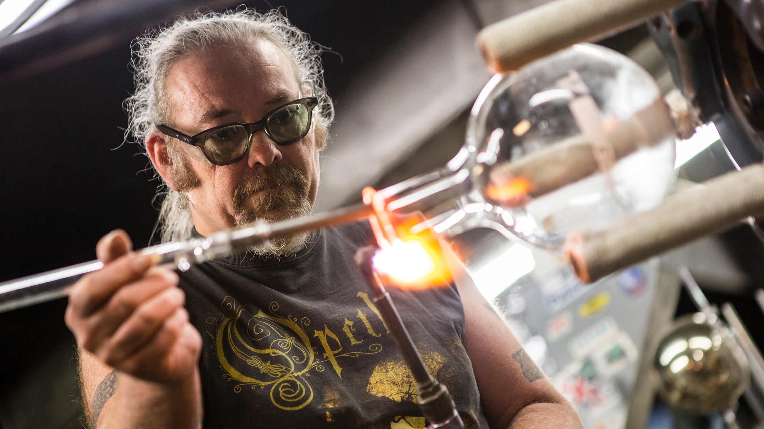 Close up portrait of a man blowing glass
