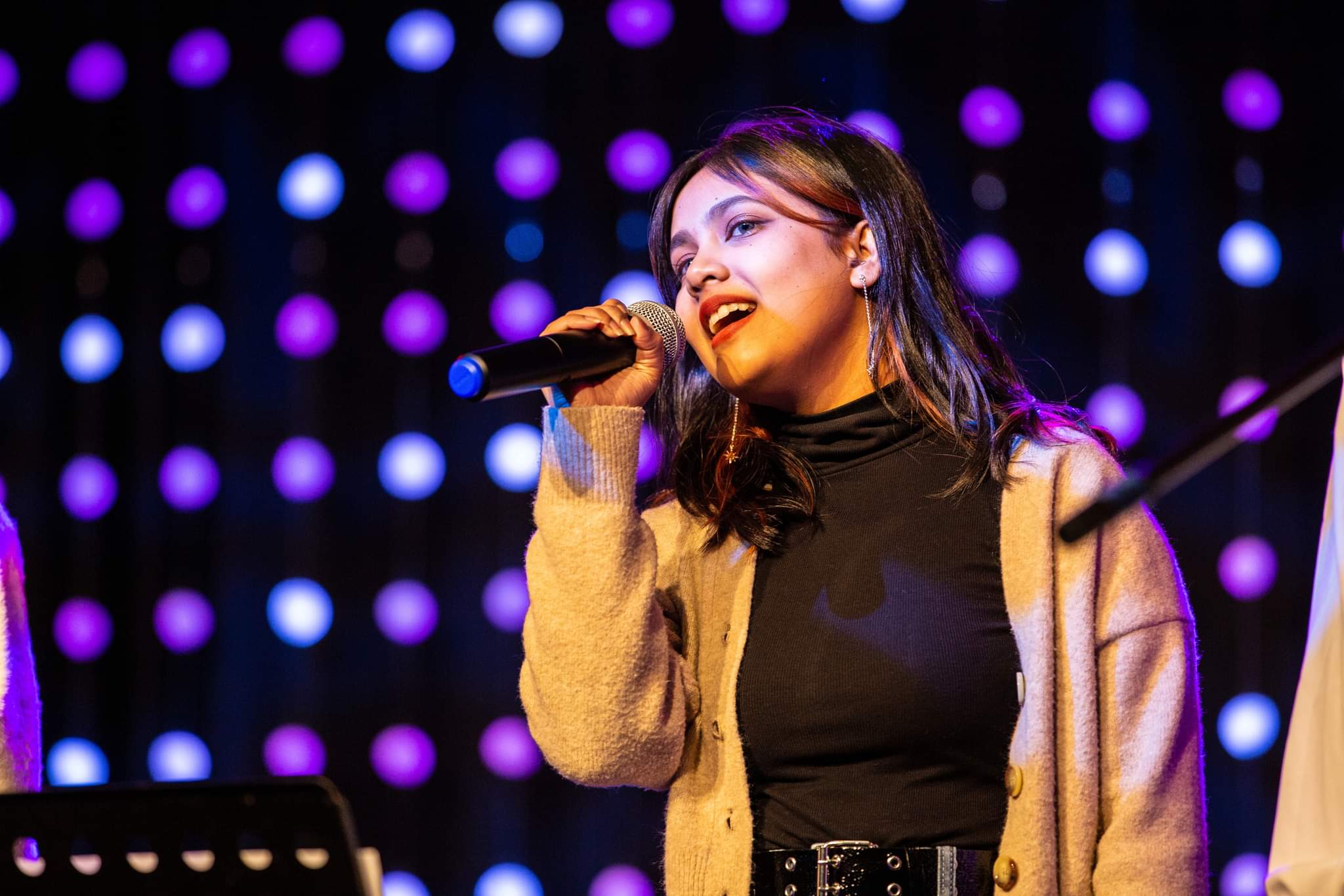 Student singing at an event