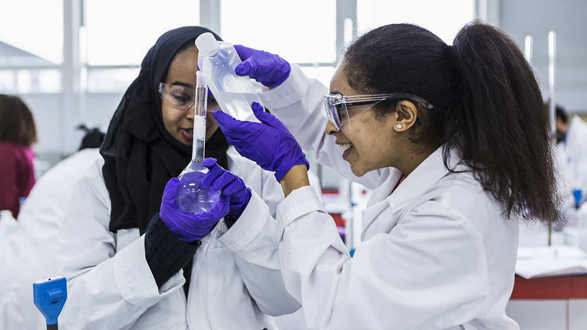 Two students carrying out an experiment together