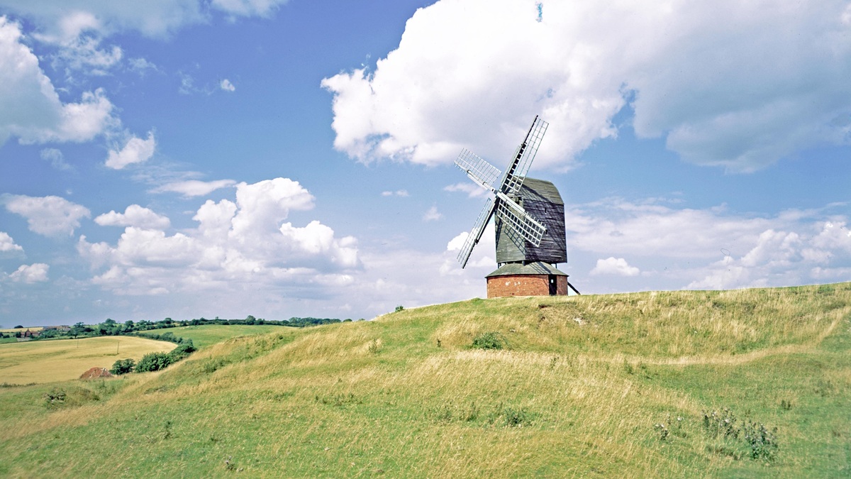 Windmill in a field under blue skies