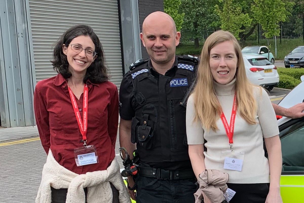 Netta Weinstein stood outside with a police officer from the Hampshire and Isle of White Constabulary and Nicole Legate.