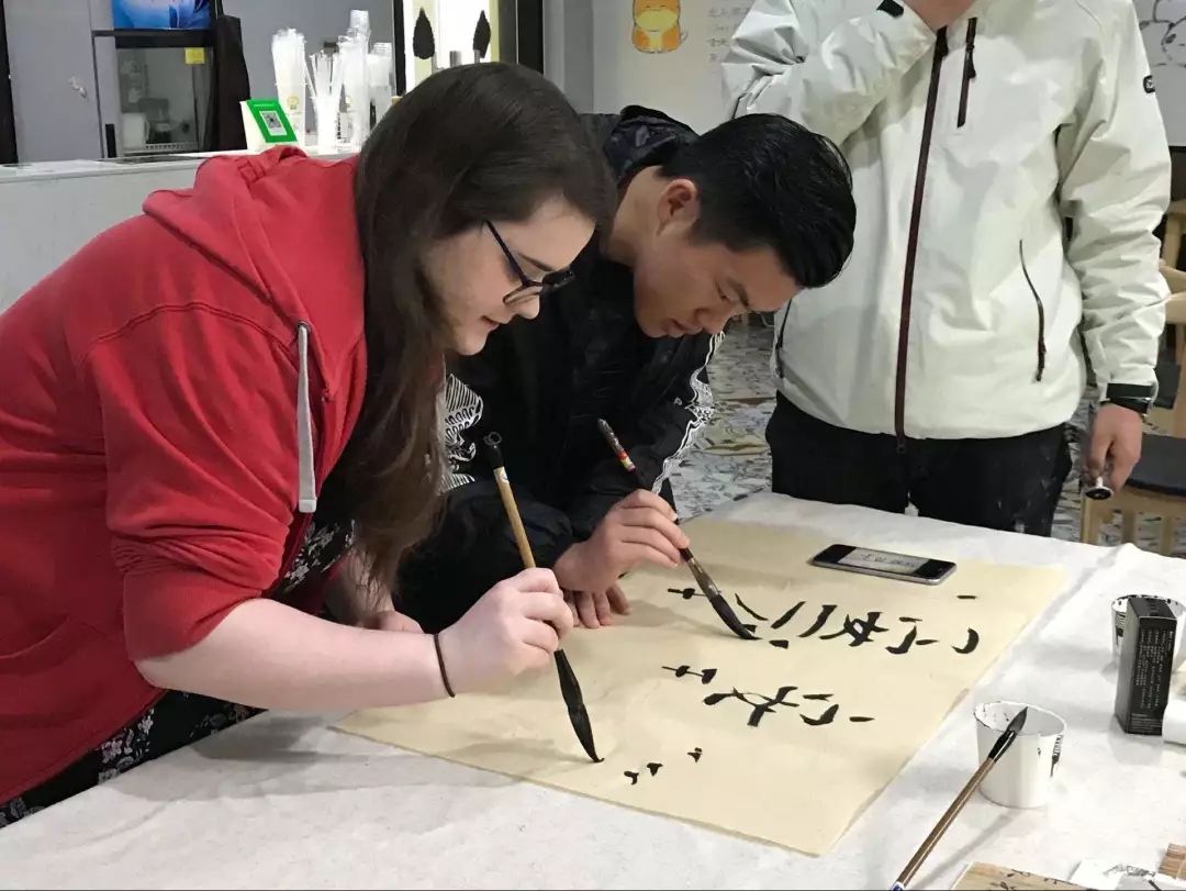 Students practice caligraphy