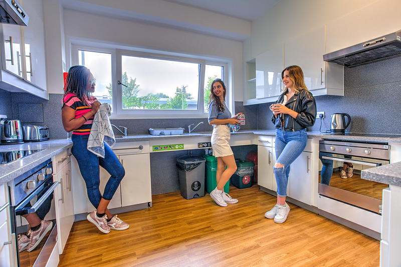Students talk in a kitchen