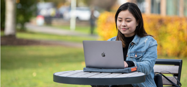 Student studying outside on a laptop