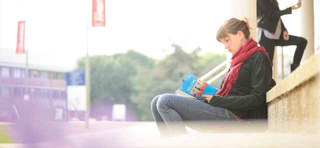 Girl reading through welcome week leaflet