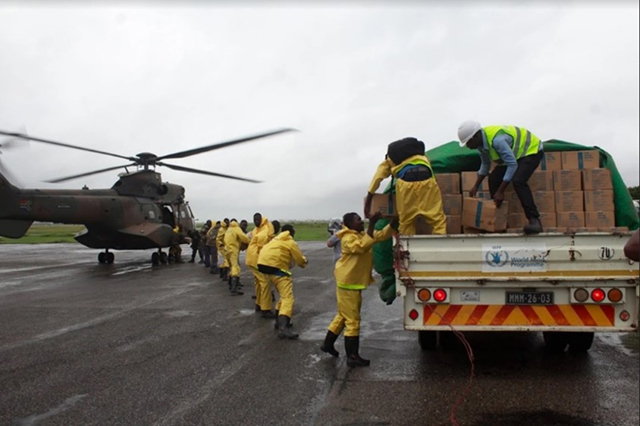 Aid being unloaded from a truck and taken to a helicopter