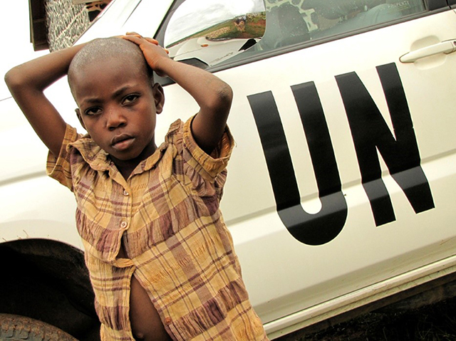 Child in front of a UN vehicle