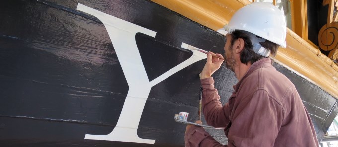 A signwriter painting the ship's name on HMS Victory.