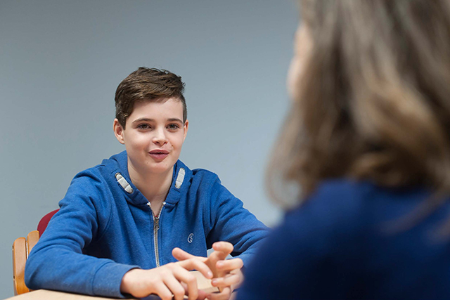 A teenage boy talking to a therapist