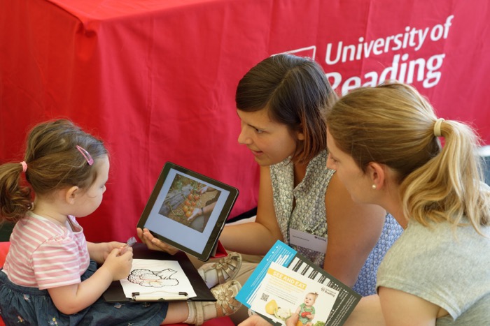 A young visitor to the Berkshire Show 2019 talking to Food and Nutrition Science researchers about vegetables.