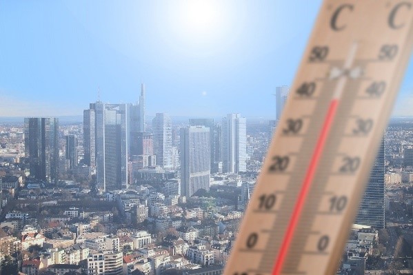 Cityscape with an image of a thermometer superimposed on it