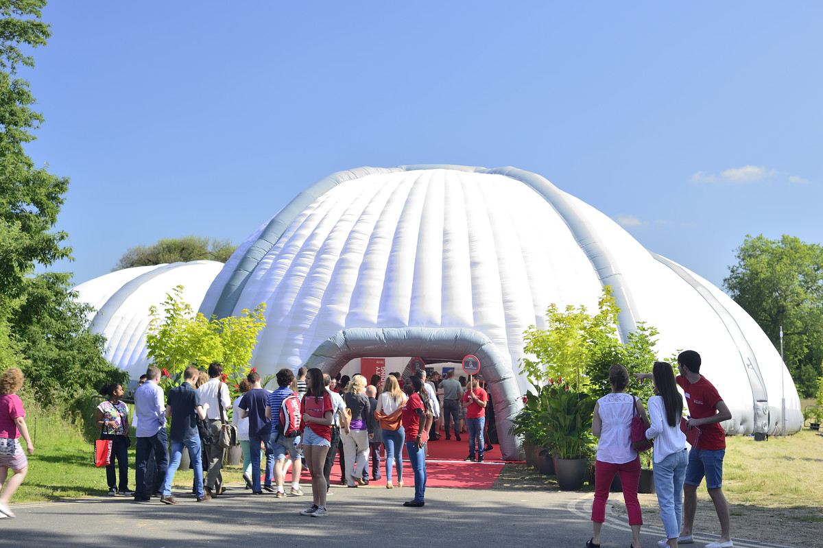 Prospective students standing outside the Open Day Dome on a bright sunny day