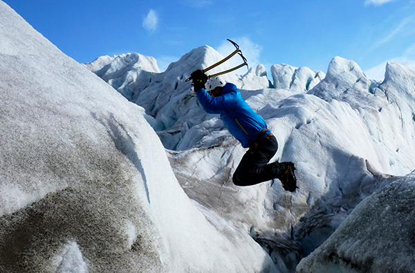 Student jumping onto a glacier