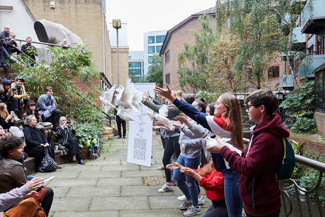 A group of children look at outside art exhibits