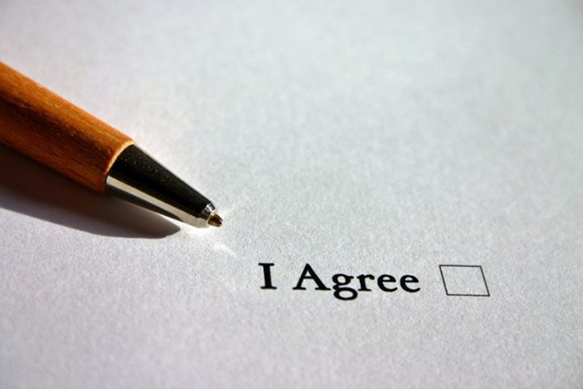 Pen positioned next to a document marked 'I agree'