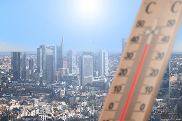 Thermometer set against the background of a cityscape