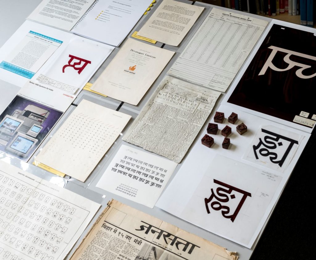 Several designer typefaces printed out on a table