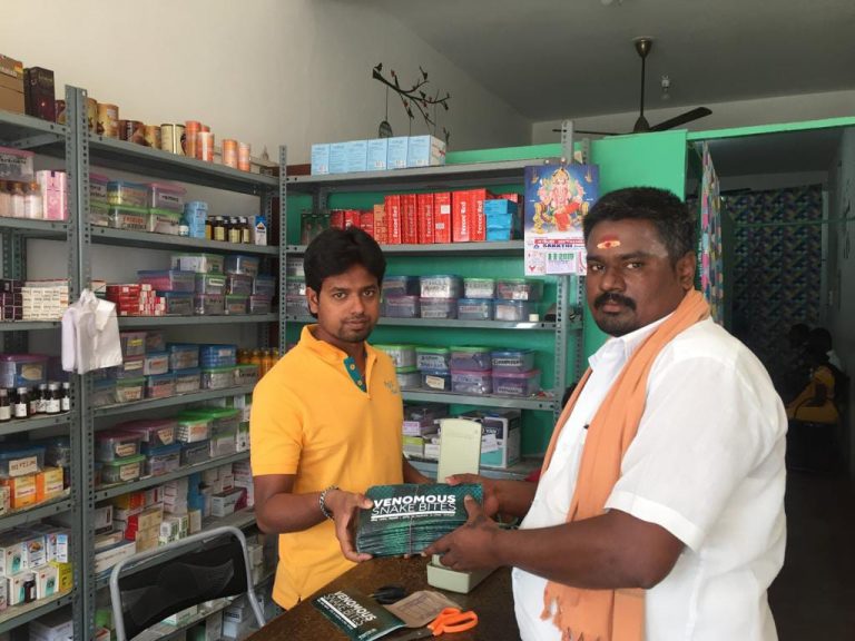 A man distributes information pamphlets in a shop