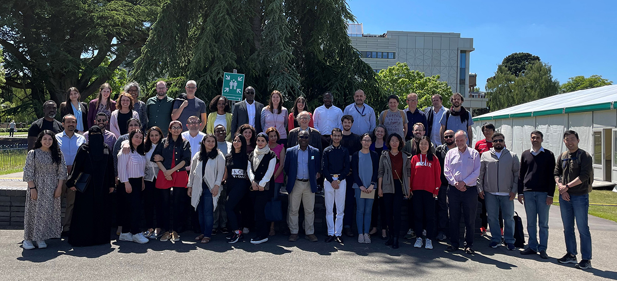 Economics staff and students in a group photo in front of University of Reading library