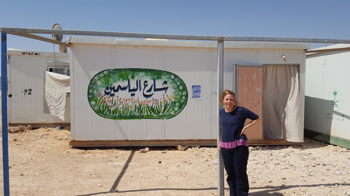 Yasmine Shamma stands in front of a sign