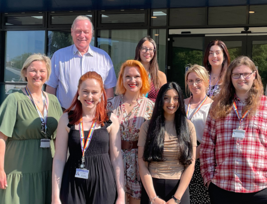 The International Student Advisory Team smiling for a group photo outside the Student Services Building.