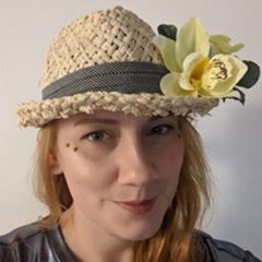 Laura with a straw hat on. Stars on face.