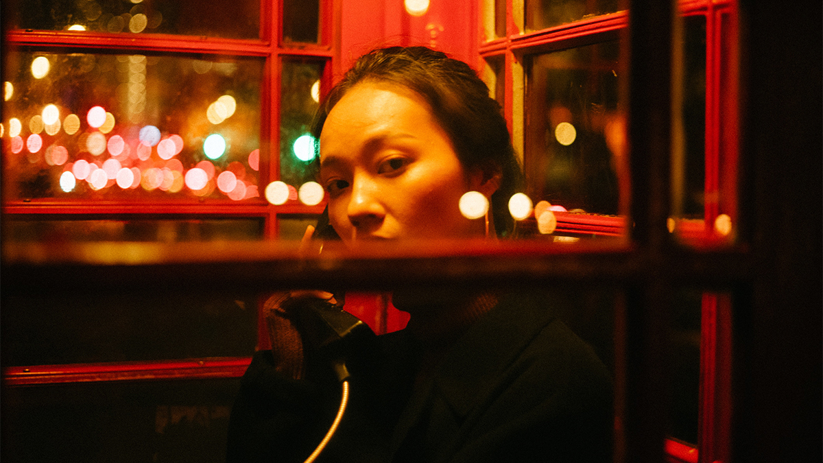 Woman in phone booth in Anwar Johari's Forget Me Not film