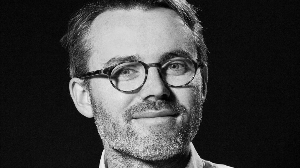 Black and white portrait of film lecturer Dr Adam O'Brien