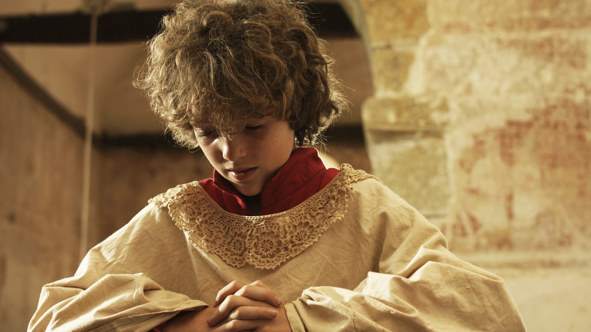 Screenshot from Dominic Lees film of altarboy praying