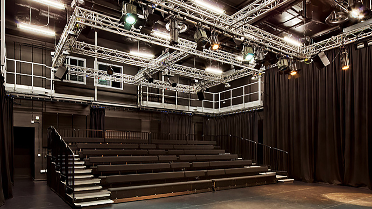 Large stadium seating area inside Bulmershe theatre and view of lighting rigs
