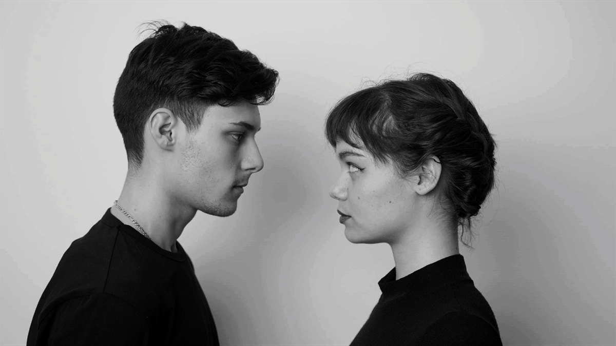 Screenshot of a student film of two people standing face to face in black and white