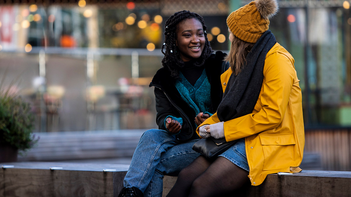 Two students chatting in Reading town centre