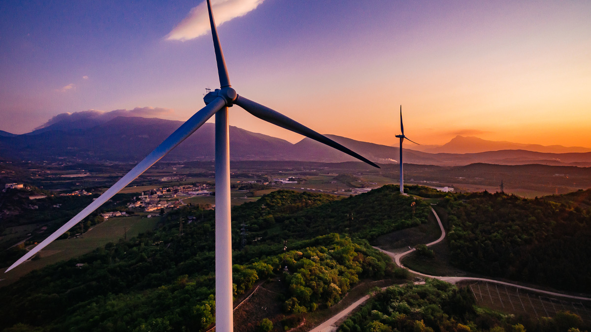 aerial view of wind turbines at sunset