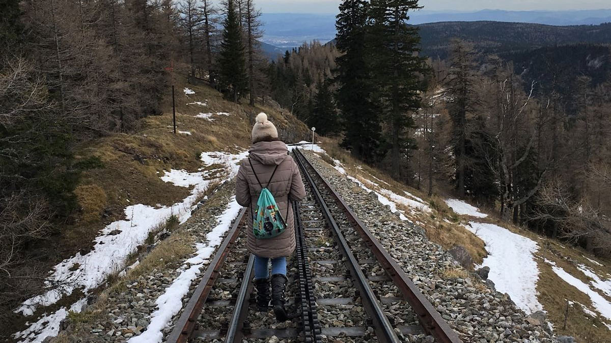 A picture of Mollie walking along a railway track in Austria