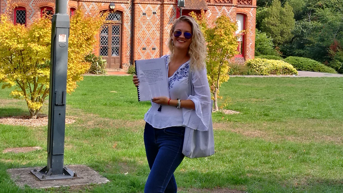 A photo of Kalina holding her final thesis