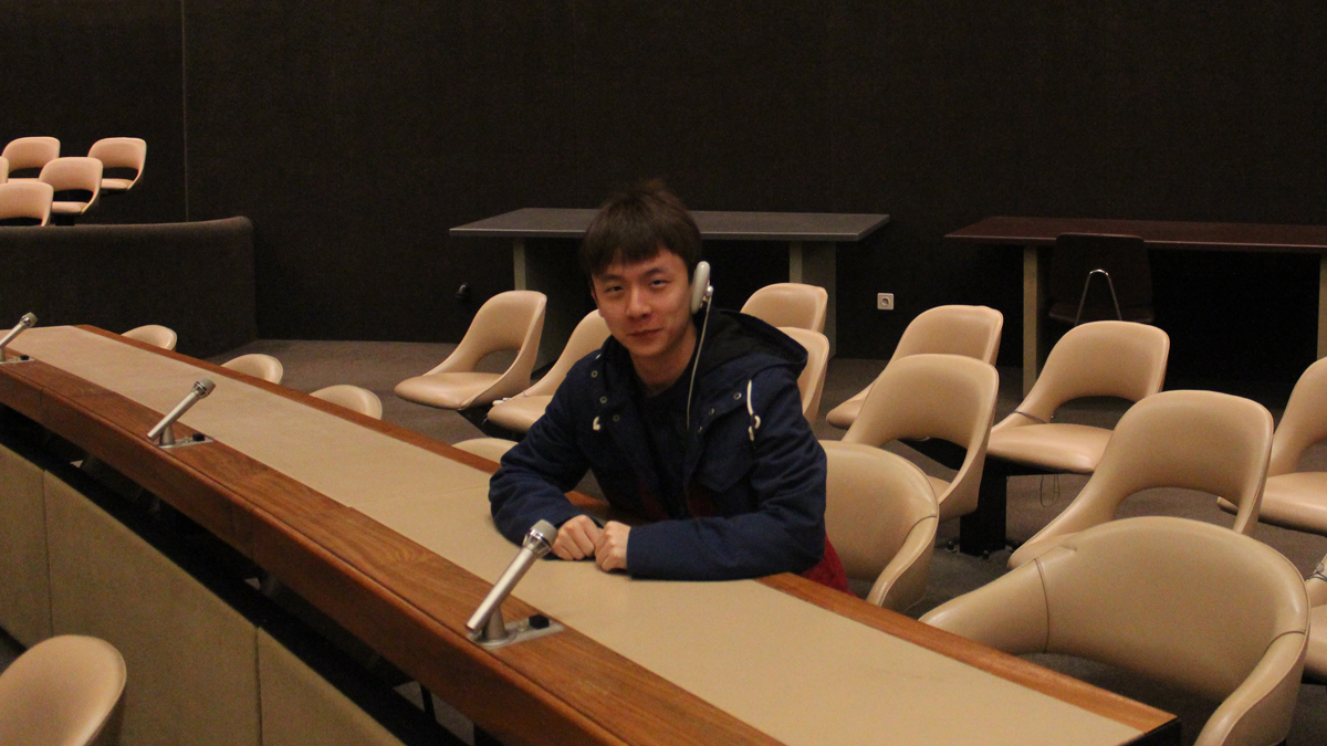 A photo of Wenxiao in a conference room.