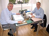 Matthias Rapp (left) and Ian Wilkinson signing the completion documents for Rapp UK