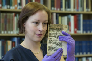 Special Collections Librarian Erika Delbecque with the Caxton leaf