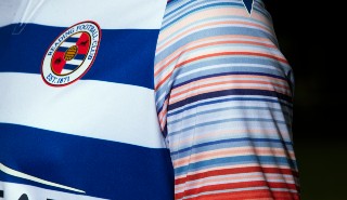 The Reading Football Club home kit featuring the climate stripes on its sleeves