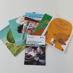 A collection of children's story books in different languages, and a booklet on multilingualism for families