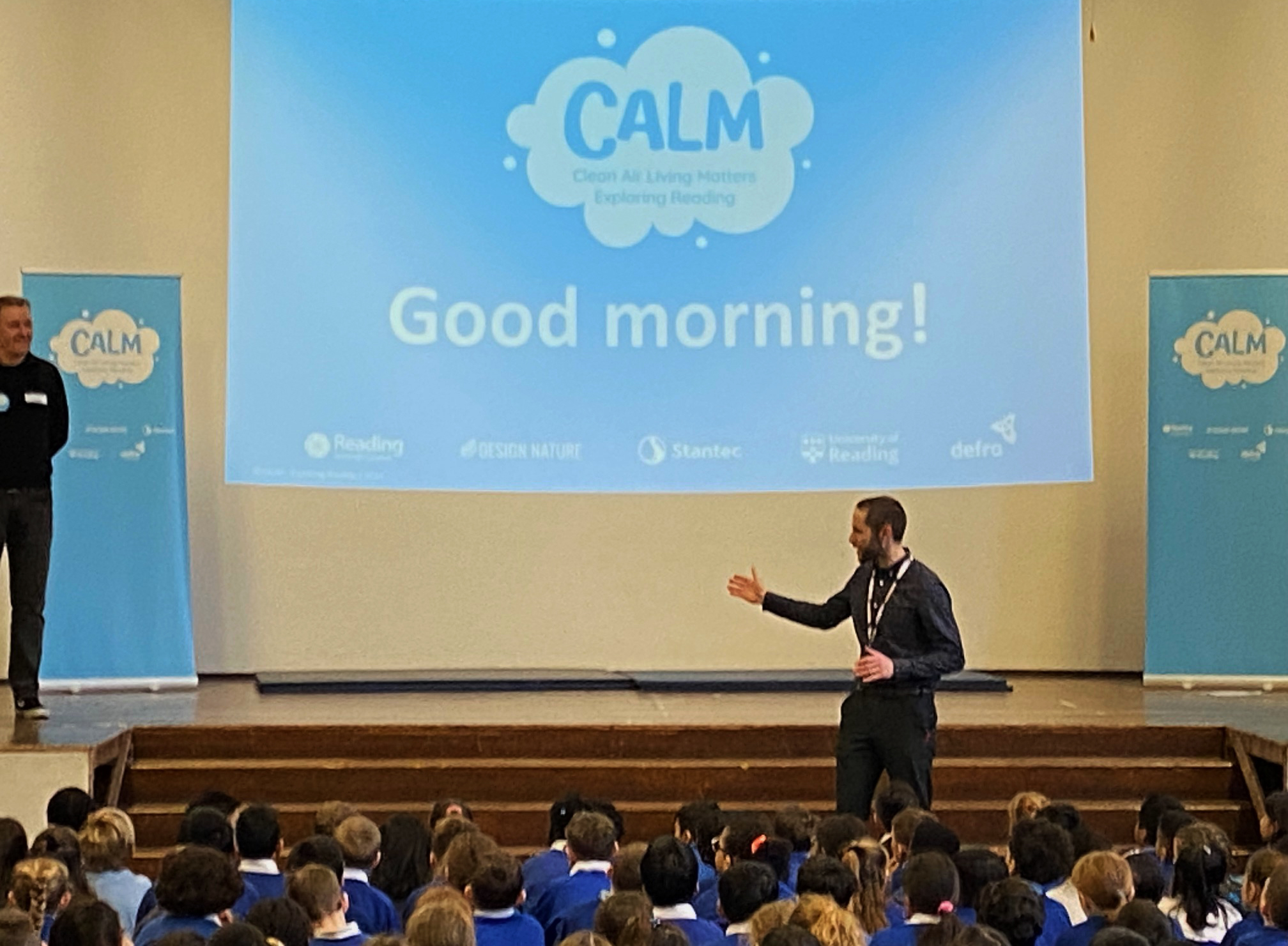 A man gives a talk to pupils from Geoffrey Field Junior School